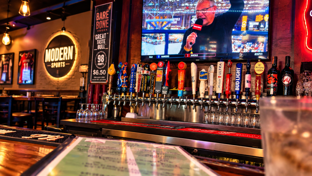 Bar area at Modern Sports Restaurant in Taylorsville, Georgia, with draft beer taps and sports playing on the television.